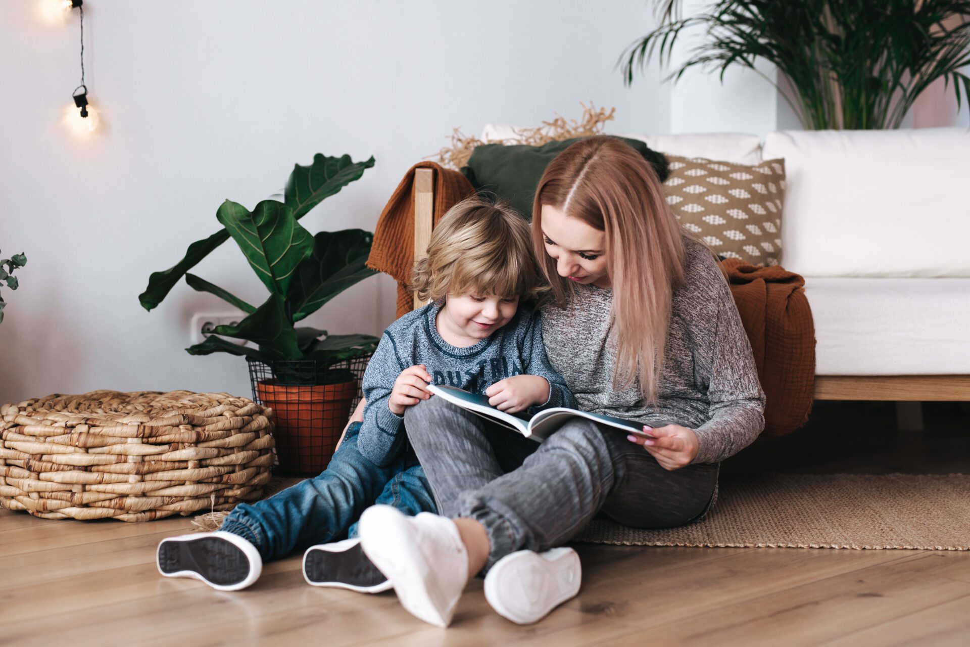 Mother reading book to her son at home
